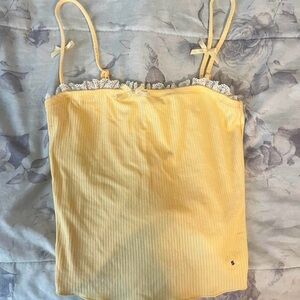 Cute pastel yellow tank with bows and lace front